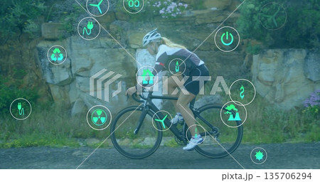 Pedaling female cyclist wearing helmet riding rural road, with road bicycle and green energy icons Pedaling female cyclist wearing helmet riding rural road, with road bicycle and green energy icons 135706294