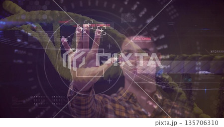 Man wearing plaid shirt manipulating holographic interface in lab, displaying glowing DNA helix Man wearing plaid shirt manipulating holographic interface in lab, displaying glowing DNA helix 135706310