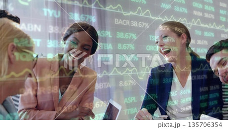 Analyzing financial data, team wearing business attire using laptop at meeting table, stock overlay Analyzing financial data, team wearing business attire using laptop at meeting table, stock overlay 135706354