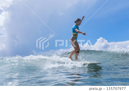 Peaceful Surf Dawn, Calm Dawn Sees Woman Rider Enjoying Morning Surf Session 135707977