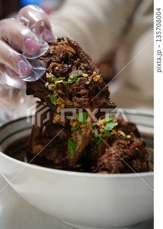 Traditional Thai Spicy Pork Ribs Soup (Tom Saap) with Fresh Chili and Green Onion Topping 135708004