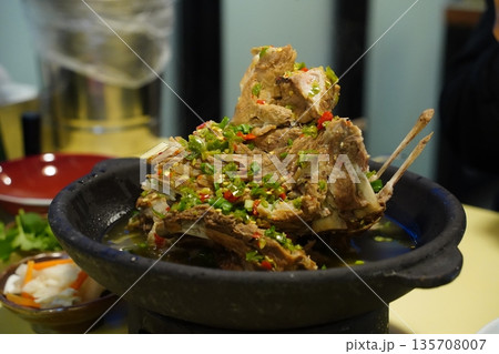 Traditional Thai Spicy Pork Ribs Soup (Tom Saap) with Fresh Chili and Green Onion Topping Traditional Thai Spicy Pork Ribs Soup (Tom Saap) with Fresh Chili and Green Onion Topping 135708007