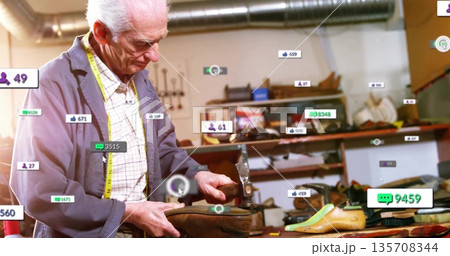 Inspecting shoemaker wearing blue jacket in shoe repair shop, with leather upper and metal last 135708344