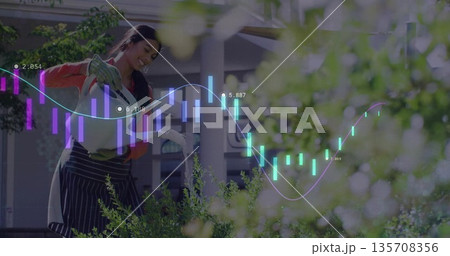 Woman wearing apron and gloves watering plants with watering can on garden veranda, graph overlay Woman wearing apron and gloves watering plants with watering can on garden veranda, graph overlay 135708356
