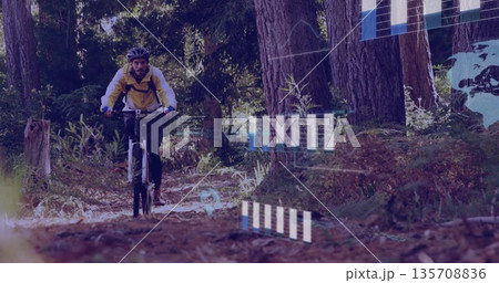 Cyclist pedaling bike along pine trail in yellow jacket, helmet and backpack, with HUD overlays Cyclist pedaling bike along pine trail in yellow jacket, helmet and backpack, with HUD overlays 135708836