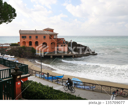 Traditional Ligurian building on island in sea. Landscape on cloudy day. Nature in Italy. Traditional Ligurian building on island in sea. Landscape on cloudy day. Nature in Italy. 135709077