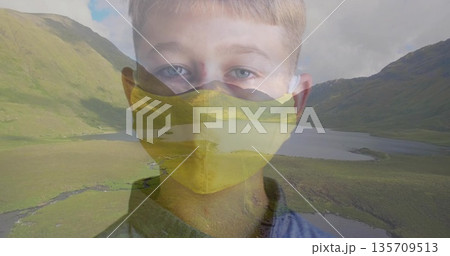 Blending boy portrait with mountain lake landscape, featuring yellow mask and blue shirt Blending boy portrait with mountain lake landscape, featuring yellow mask and blue shirt 135709513