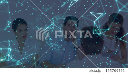 Collaborating team analyzing data in modern conference room with holographic network overlay 135709561
