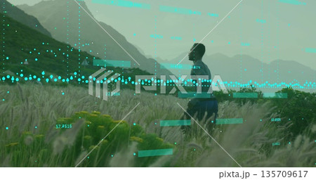 Running athlete in sportswear navigating field near ridges with wildflowers and teal data overlays 135709617