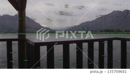 Framing wooden deck railing guiding gaze across calm lake water, with distant mountain range behind Framing wooden deck railing guiding gaze across calm lake water, with distant mountain range behind 135709681