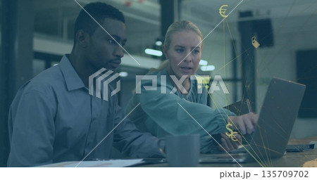 Pointing at laptop screen while colleagues collaborating in open plan office, with finance icons Pointing at laptop screen while colleagues collaborating in open plan office, with finance icons 135709702