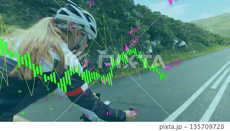Riding cyclist wearing helmet monitoring computer on mountain road, with neon-green charts overlay Riding cyclist wearing helmet monitoring computer on mountain road, with neon-green charts overlay 135709728