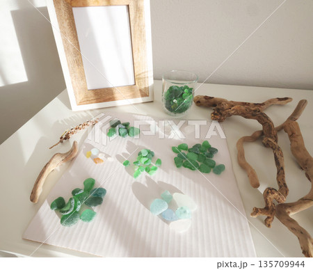 Collection of various sea glass and driftwood for crafting. Hobbies and handicrafts. Mock-up frame for design. Collection of various sea glass and driftwood for crafting. Hobbies and handicrafts. Mock-up frame for design. 135709944