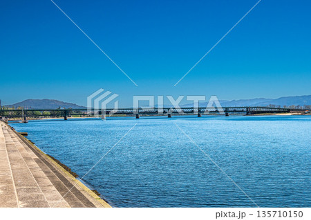 The Gustave Eiffel Bridge over the river Lima in Viana do Castelo in Portugal. Panoramic cityscape view of Viana and the Marina. The Gustave Eiffel Bridge over the river Lima in Viana do Castelo in Portugal. Panoramic cityscape view of Viana and the Marina. 135710150