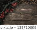 Autumn harvest flat lay on dark rustic wood with rowan berries, acorns and textured dry branch, copy space. 135710809