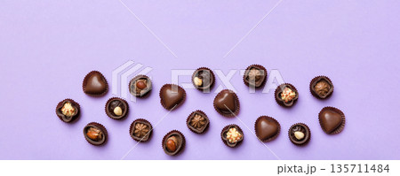 Different kinds of chocolates on colored table close-up. Top View and Flat Lay with copy space 135711484