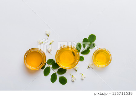 honey jar with acacia flowers and leaves. fresh honey top view flat lay honey jar with acacia flowers and leaves. fresh honey top view flat lay 135711539