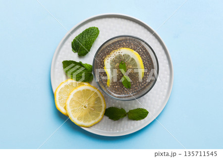 Healthy breakfast or morning with chia seeds lemon and mint on table background, vegetarian food, diet and health concept. Chia pudding with lemon and mint 135711545