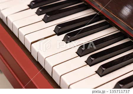 Close up of piano keyboard with black and white keys, classic musical instrument detail Close up of piano keyboard with black and white keys, classic musical instrument detail 135711737