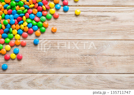 Mixed collection of colorful candy, on colored background. Flat lay, top view. frame of colorful chocolate coated candy 135711747