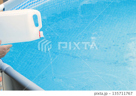 Cleaning a PVC frame pool from algae by pouring perhydrol, Concept of cleaning services Cleaning a PVC frame pool from algae by pouring perhydrol, Concept of cleaning services 135711767