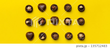 Different kinds of chocolates on colored table close-up. Top View and Flat Lay Different kinds of chocolates on colored table close-up. Top View and Flat Lay 135712483