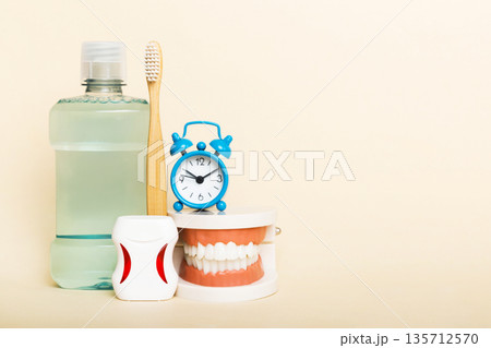 Mouthwash and other oral hygiene products on colored table top view with copy space. Flat lay. Dental hygiene. Oral care kit. Dentist concept Mouthwash and other oral hygiene products on colored table top view with copy space. Flat lay. Dental hygiene. Oral care kit. Dentist concept 135712570