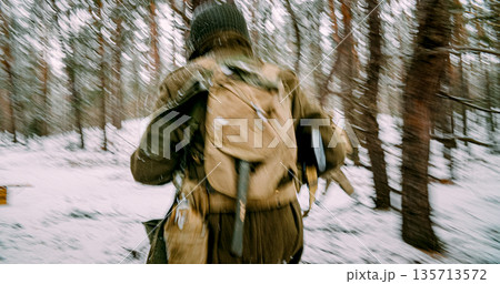 Re-enactor Dressed As American Infantry Soldier Fast Running By Forest In Cold Winter Day. Soldier Retreats From Enemy Attack. Usa Army Soldiers Of World War Ii. Will To Life. Heroes Of War. Chasing Re-enactor Dressed As American Infantry Soldier Fast Running By Forest In Cold Winter Day. Soldier Retreats From Enemy Attack. Usa Army Soldiers Of World War Ii. Will To Life. Heroes Of War. Chasing 135713572
