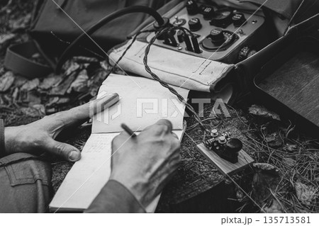 Russian Soviet Infantry Red Army Soldier In World War II using Russian Soviet Portable Radio Transceiver In Trench Entrenchment In Spring Autumn Forest. 4K. Headphones And Telegraph Key. Close Up Russian Soviet Infantry Red Army Soldier In World War II using Russian Soviet Portable Radio Transceiver In Trench Entrenchment In Spring Autumn Forest. 4K. Headphones And Telegraph Key. Close Up 135713581