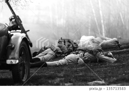 Re-enactor Dressed As Soviet Russian Soldier Lies Slain In Reconstruction Of Battles World War I Near Combat Sidecar. Soviet Russian Infantry Soldier In World War Ii. Black And White Video Re-enactor Dressed As Soviet Russian Soldier Lies Slain In Reconstruction Of Battles World War I Near Combat Sidecar. Soviet Russian Infantry Soldier In World War Ii. Black And White Video 135713583
