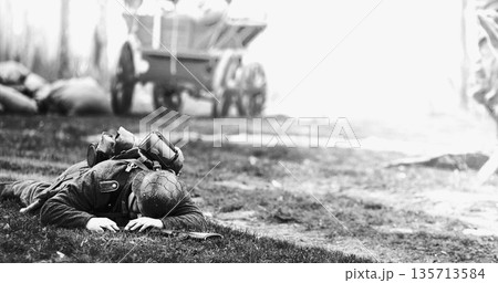 German Infantry Soldier In World War Ii. Re-enactor Dressed As German Wehrmacht Soldier Lies Slain In Reconstruction Of Battles World War Ii. Win Of Soviet Army In War. Black And White Video German Infantry Soldier In World War Ii. Re-enactor Dressed As German Wehrmacht Soldier Lies Slain In Reconstruction Of Battles World War Ii. Win Of Soviet Army In War. Black And White Video 135713584