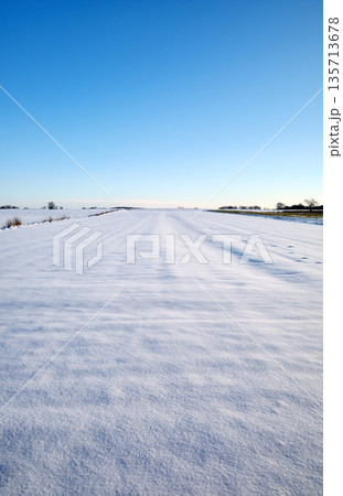 A farm field covered with snow in winter. A farm field covered with snow in winter. 135713678