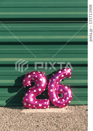 pink balloons forming the number 26 against a wall pink balloons forming the number 26 against a wall 135713906