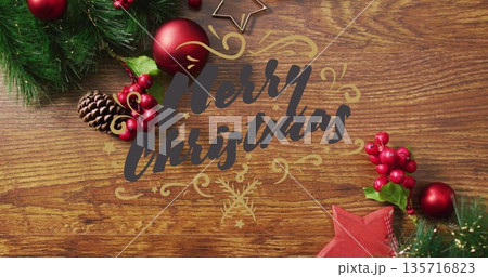 Merry Christmas text image over festive decorations on wooden background Merry Christmas text image over festive decorations on wooden background 135716823