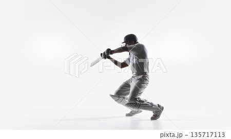 Cricket batsman kneeling follow through shot in studio isolated. 135717113