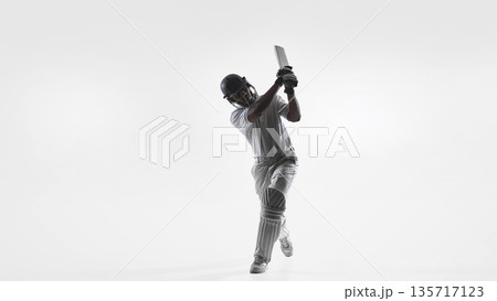 Cricket batsman follow through swing technique in studio isolated on white. Cricket batsman follow through swing technique in studio isolated on white. 135717123
