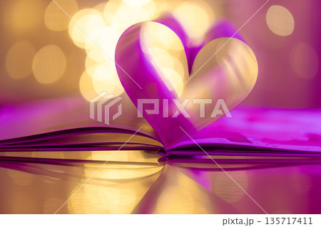 Elegant vertical purple and gold Valentines Day heart made from folded book pages, glowing bokeh lights, romantic love background, dreamy holiday romance concept Elegant vertical purple and gold Valentines Day heart made from folded book pages, glowing bokeh lights, romantic love background, dreamy holiday romance concept 135717411