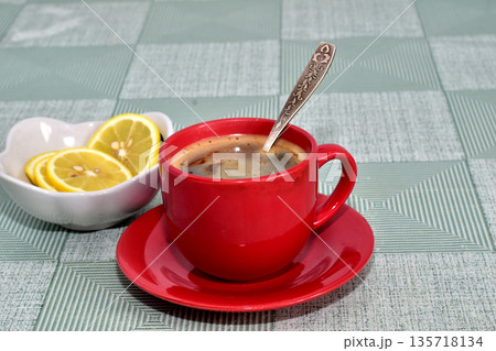 A cup of tea is on the table. 135718134