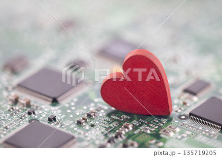 Small red heart on computer circuit board. Internet dating concept. 135719205