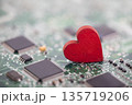Small red heart on computer circuit board. Internet dating concept. 135719206