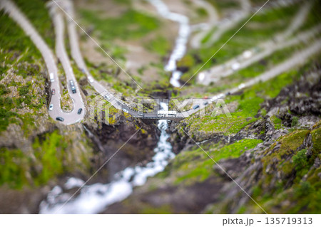 Tilt shift miniature effect. Mountain serpentine road Trollstigen in Norwegian valley. 135719313