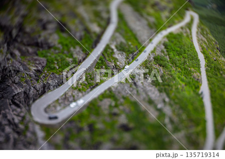 Tilt shift miniature effect. Mountain serpentine road Trollstigen in Norwegian valley. 135719314