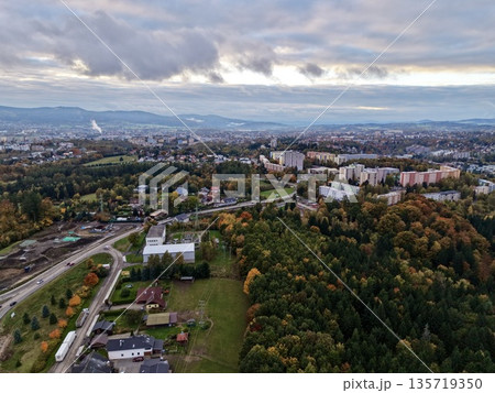 overhead autumnal cityscape view, highaltitude scene of fall neighborhood beneath industrial skyline 135719350