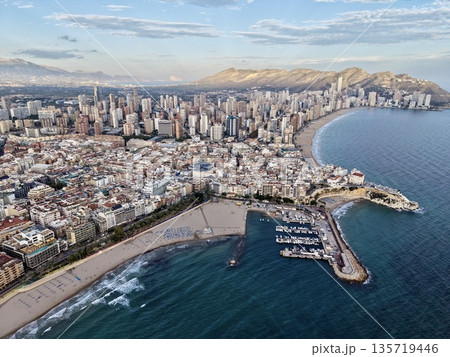 elegant harbor with boats nearby, exclusive marina setting with neighboring beach and vibrant city elegant harbor with boats nearby, exclusive marina setting with neighboring beach and vibrant city 135719446