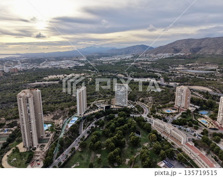 aerial imagery showcasing seaside landmark towers amidst scenic natural surroundings during evening hours aerial imagery showcasing seaside landmark towers amidst scenic natural surroundings during evening hours 135719515