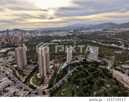 aerial perspective capturing sunset illumination on shoreline skyline with towering structures and roadways 135719517