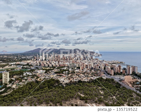 hilltop shot of vibrant coastal metropolis, expansive aerial image capturing shoreline and urban sprawl hilltop shot of vibrant coastal metropolis, expansive aerial image capturing shoreline and urban sprawl 135719522