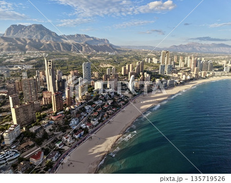sunrise over coast, morning sunlight bathes luxurious coastlines and towering structures beautifully 135719526