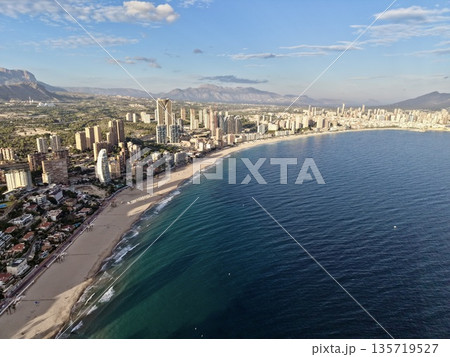 beachfront scene with urban background, seaside aerial view highlighting resort and mountain backdrop 135719527