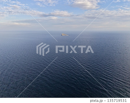 serene maritime vista, calm ocean with distant island, peaceful sea view showing horizon and ship serene maritime vista, calm ocean with distant island, peaceful sea view showing horizon and ship 135719531
